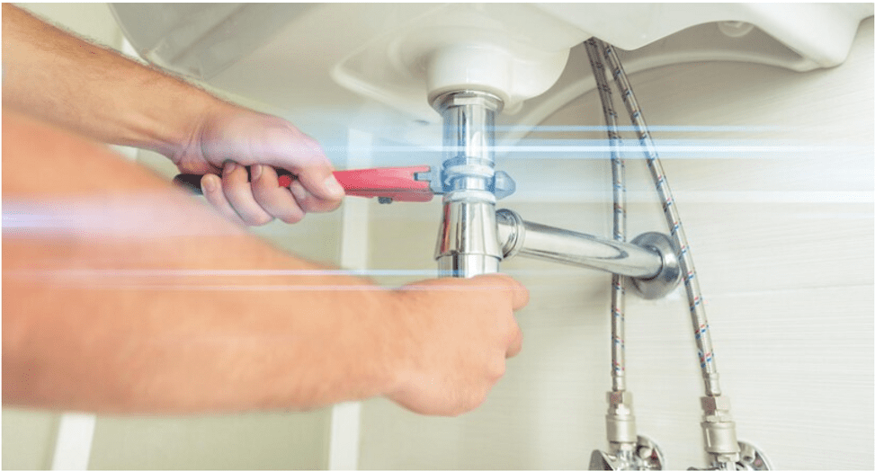 Hands using tool on pipe fittings