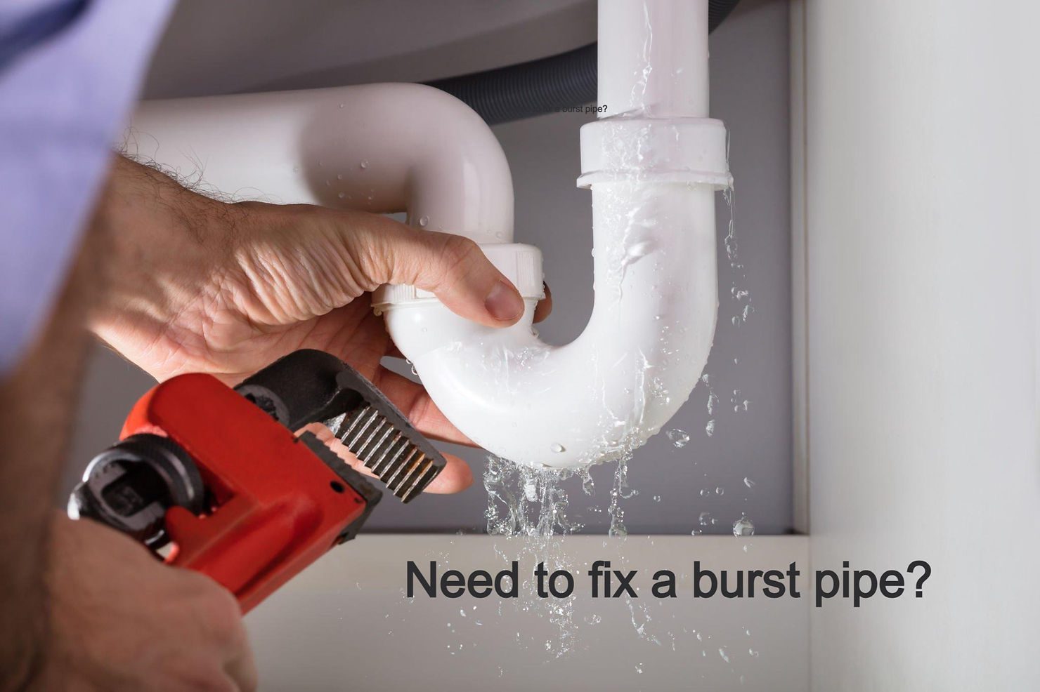 Plumber fixing leaking pipe under sink