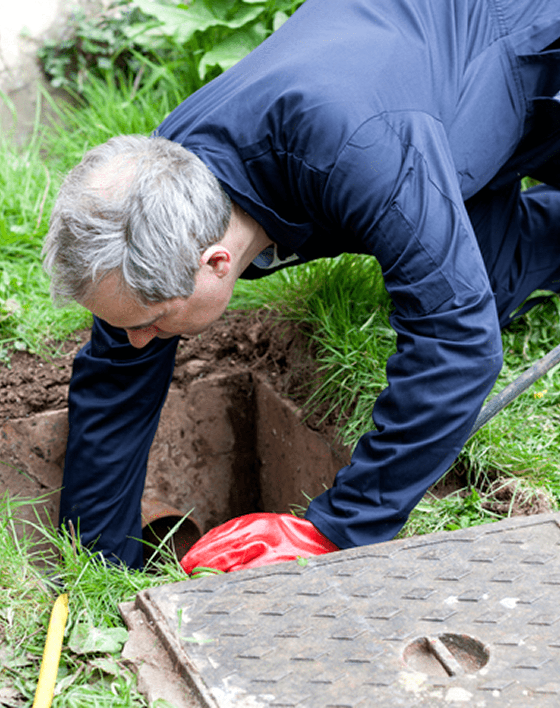 Man checking sewer access