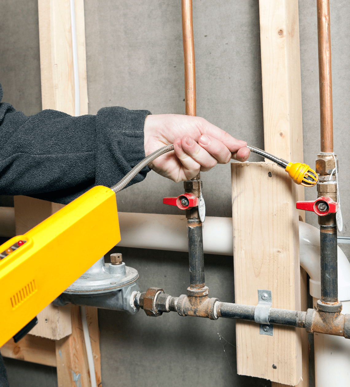 Technician inspecting gas pipes