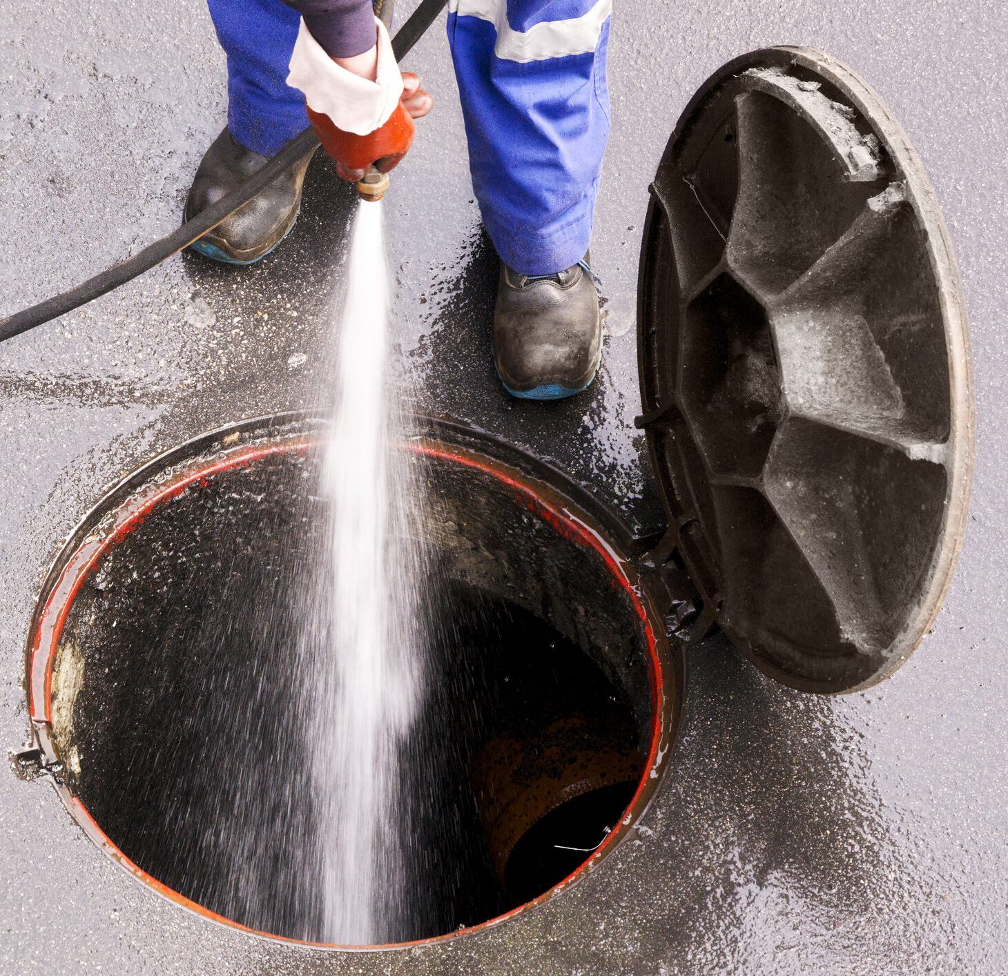 Low Section Of Man Cleaning Manhole