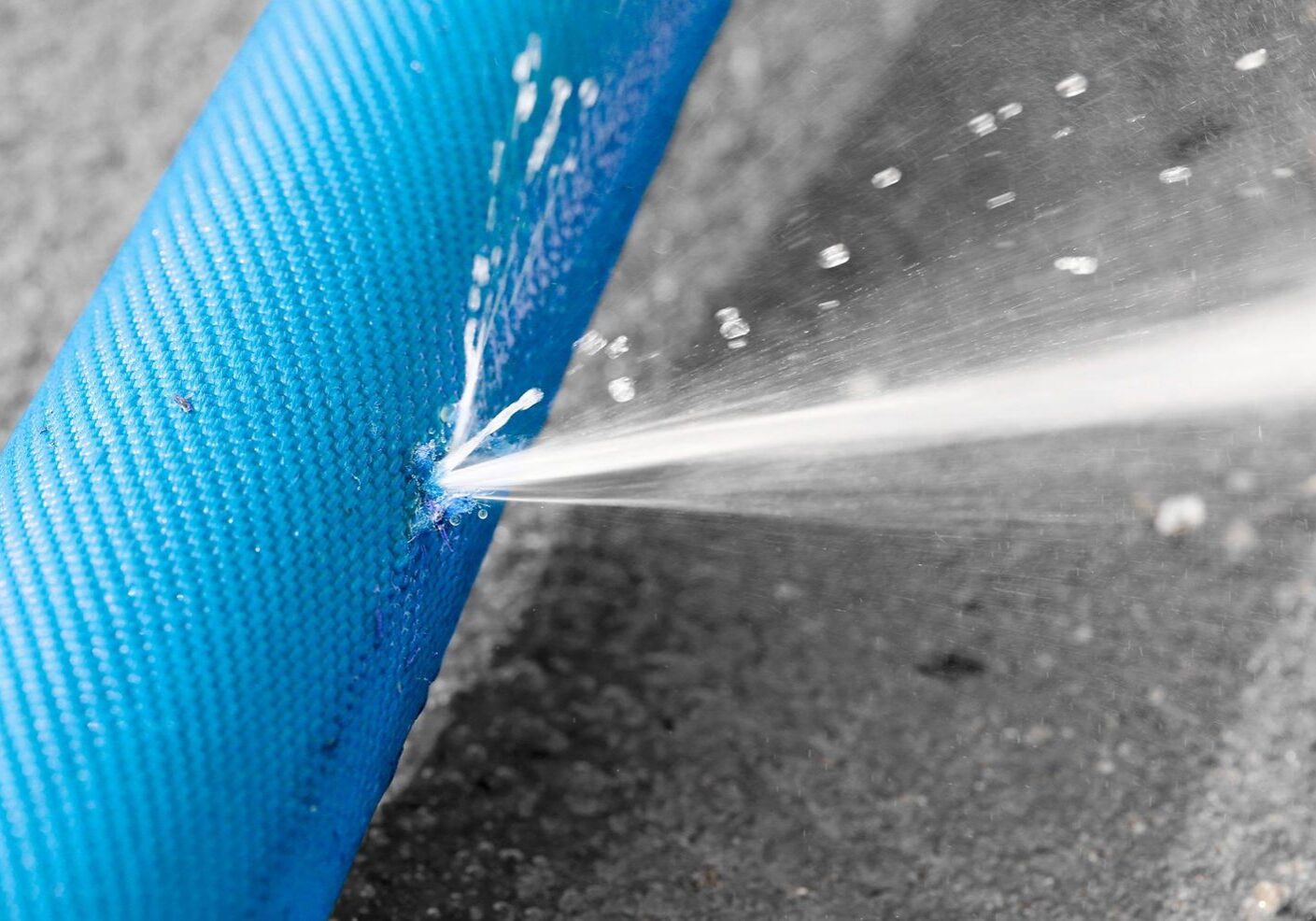 Water spraying from damaged hose