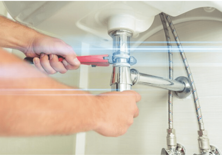 Hands using tool on pipe fittings